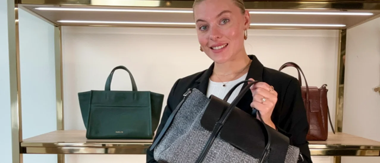 A Radley host presenting a herringbone tote on the shop floor during a live show.