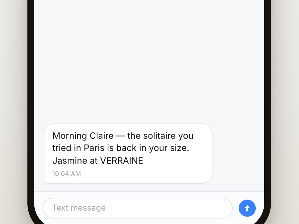 A text message on the client's phone from the store's number: the solitaire she tried in Paris is back in her size, signed by her advisor.